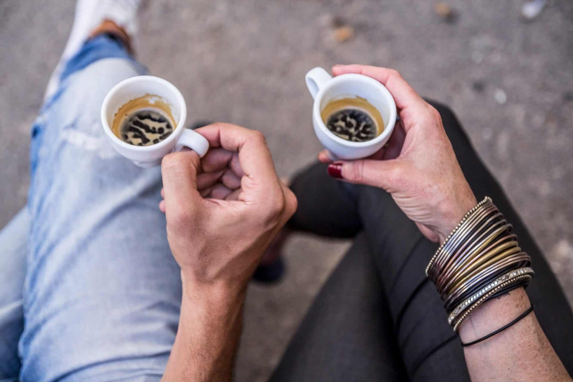 close up on the two hands holdimg coffee